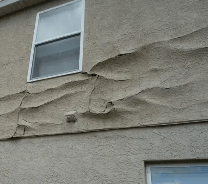 Warped stucco damage