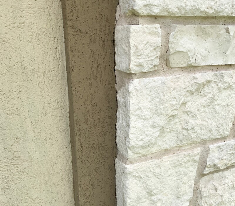 Stucco meets stonework crack